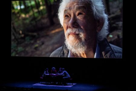 David Suzuki, an 80-year old Japanese-Canadian man, appears on a film screen in close up.